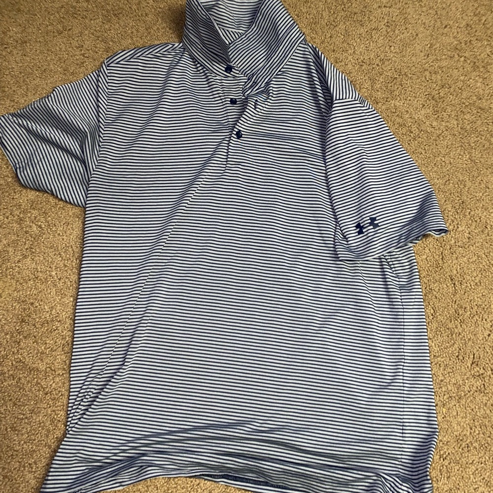 Under armour golf. Has a golf course logo on the sleeve.